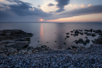 Magnificent cloudy sunset over the sea. Spring sunset, landscape, seascape.