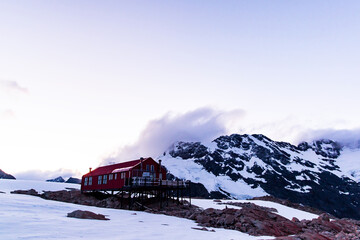 Mueller Hut during the sunset at the top of a snowy mountain of mount cook national park in the south island of new zealand