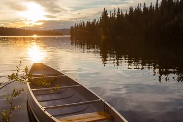 Fotobehang Frenchman Lake Yukon Canada canoe sunset scene © PiLensPhoto