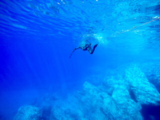 Fototapeta na wymiar spearfishing in the blue mediterranean sea water