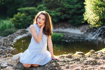 Pretty girl pose to camera at park with sunlight background