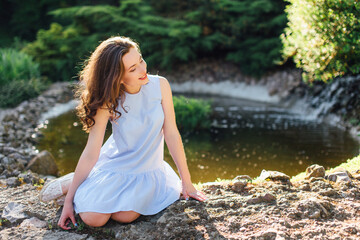 Pretty girl pose to camera at park with sunlight background