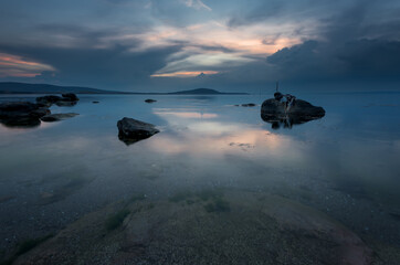 Magnificent cloudy sunset over the sea. Spring sunset, landscape, seascape.