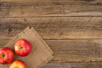 Red apples on the old wooden table.