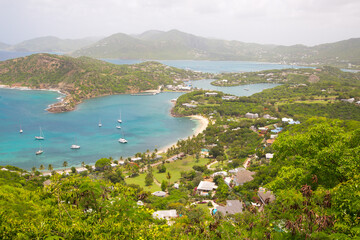 Antigua, Caribbean islands,  English harbour view with Freeman’s bay and yachts anchored by the beach 
