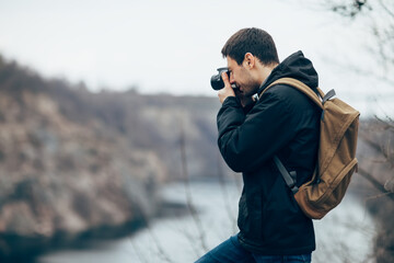 Handsome man takes pictures of nature