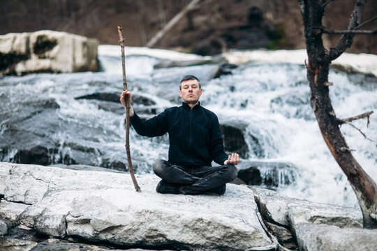 Man meditating with cliff on waterfall like sensei