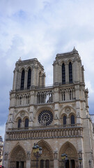 Fototapeta na wymiar Photo of famous Notre Dame cathedral on a cloudy spring morning, Paris, France