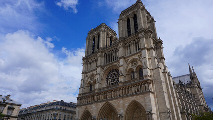 Fototapeta premium Photo of famous Notre Dame cathedral on a cloudy spring morning, Paris, France