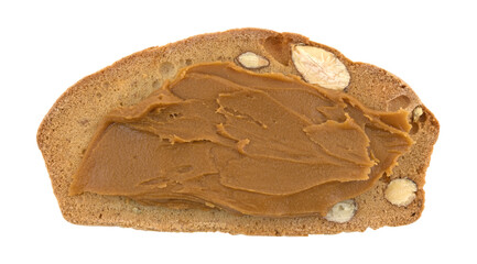 Almond pistachio crisp bread slice with cookie butter isolated on a white background.