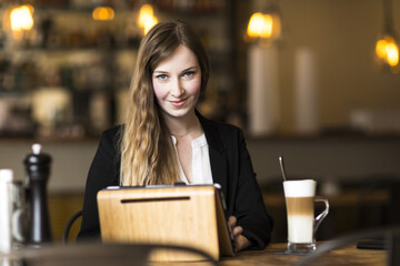 young business woman working at cafe at break