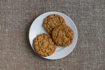 Cookies on a white plate. Background burlap