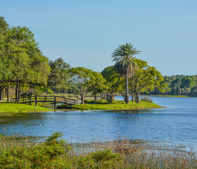 Fototapeta na wymiar A beautiful day for a walk and the view of the wood bridge to the island at John S. Taylor Park in Largo, Florida.