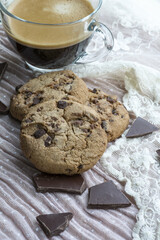 Cup of espresso with two cookies with dark chocolate on the pink background