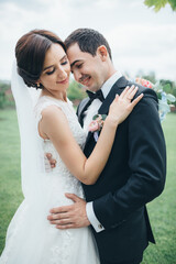 The charming brides embracing and standing in the yard