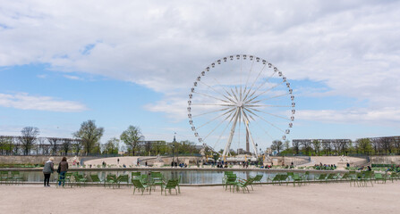 Landscape of Tuileries garden with Ferris wheel in Paris, France. Tuileries Garden is a public garden located between Louvre Museum and Place de la Concorde