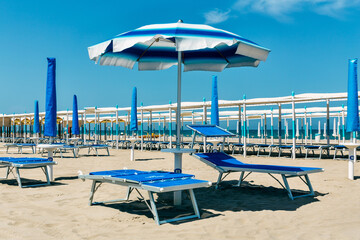 sand beach with umbrellas and chairs. Rimini, italy