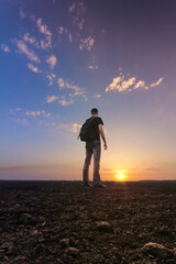 man in field at sunset / bright spring photo Ukraine