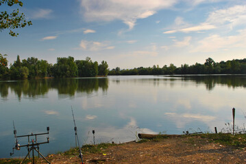 Carp fishing on lake scene with rod pod and fishing rod