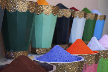 Vibrant color pigment powder in robust wooden traditional boxes in the local Medina markets also known as souks, Marrakesh, Morocco