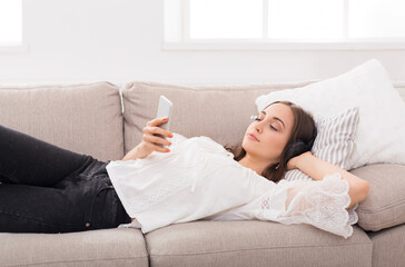 Young girl in headphones with mobile