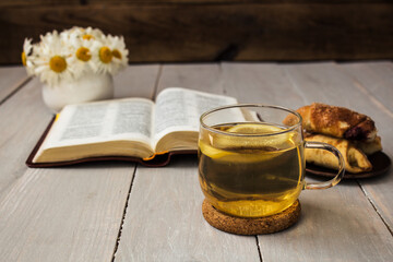 bible and tea on wooden background