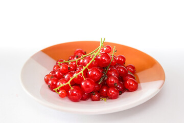 A bunch of red currants on a plate