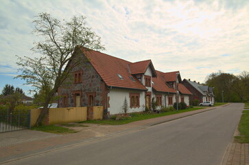 Fototapeta na wymiar Street in the town of Behrenhoff, with houses listed as monument