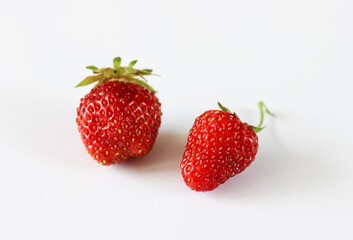 Two large strawberries on a white background