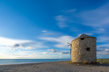 Fototapeta na wymiar Old windmill ai Gyra beach, Lefkada