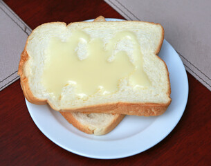 Bread topped with sweetened condensed milk.