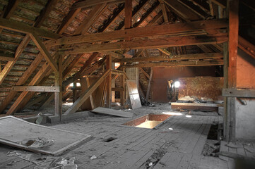 Fototapeta na wymiar Old damaged attic with wooden beams