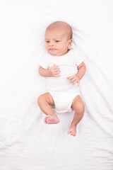 Newborn baby on white sheet