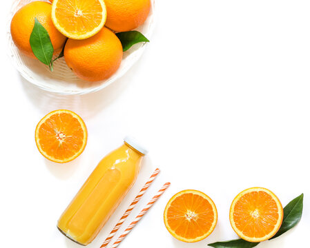 Orange juice bottle and oranges isolated on white background top view.