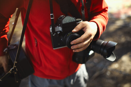 Old camera in the hands of the photographer.