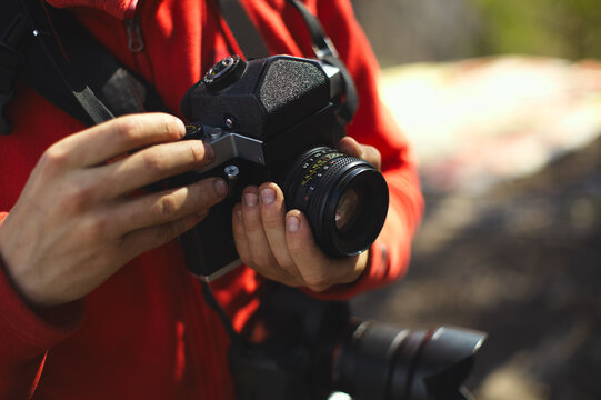 Old camera in the hands of the photographer.