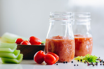 Cherry tomatoes smoothie with celery and black pepper. White background