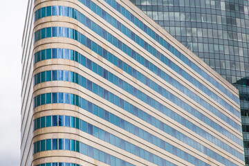 Modern blue glass wall of skyscraper. Business building, office center. Abstract architecture, fragment of modern urban geometry. Background lines