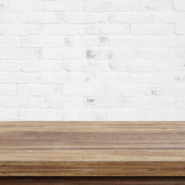 Empty wooden table over white brick wall  background, for product display montage