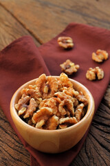 Walnut in a bowl put on fabric.