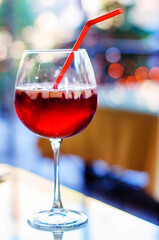 Spanish wine cold sangria drink in a glass with pieces of fruit and spices.