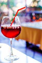 Spanish wine cold sangria drink in a glass with pieces of fruit and spices.