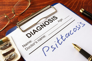 Medical form with diagnosis Psittacosis on a table.