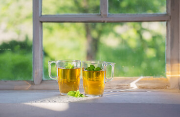 tea in glass cup on old  windowsill