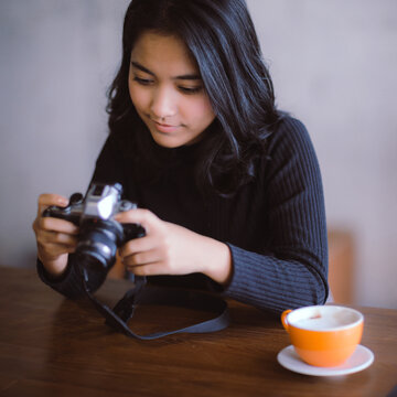 Asian woman holding Vintage camera on her holiday, Vintage color