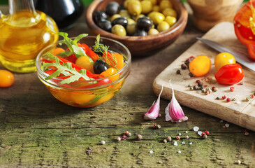 vegetables and olives on old wooden background
