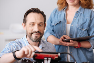 Obraz premium Cheerful delighted man pressing a button