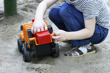 A child plays with a car.