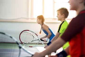 Foto op Plexiglas Happy pupils enjoying tennis game © Yakobchuk Olena
