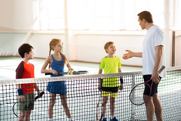 Happy kids learning rules of tennis game © Yakobchuk Olena